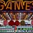 A brightly lit carnival game stall with a large 'GAMES' sign at the top surrounded by red and yellow lights. Various sports balls, including basketballs and soccer balls, are hanging from the ceiling and neatly arranged on shelves below.